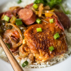 A bowl of Creole chicken and sausage gumbo served over white rice.