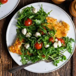 Chicken Paillard served on a white plate.