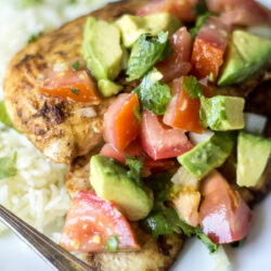 Garlic Lime Chicken topped with fresh avocado salsa served with rice.