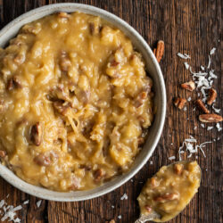 This Coconut Pecan Frosting recipe is a rich, gooey topping made with shredded coconut, chopped pecans, and a buttery caramel-like base. It's perfect for slathering on top of your favorite treat.