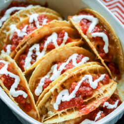 Hash brown tacos in a white dish.