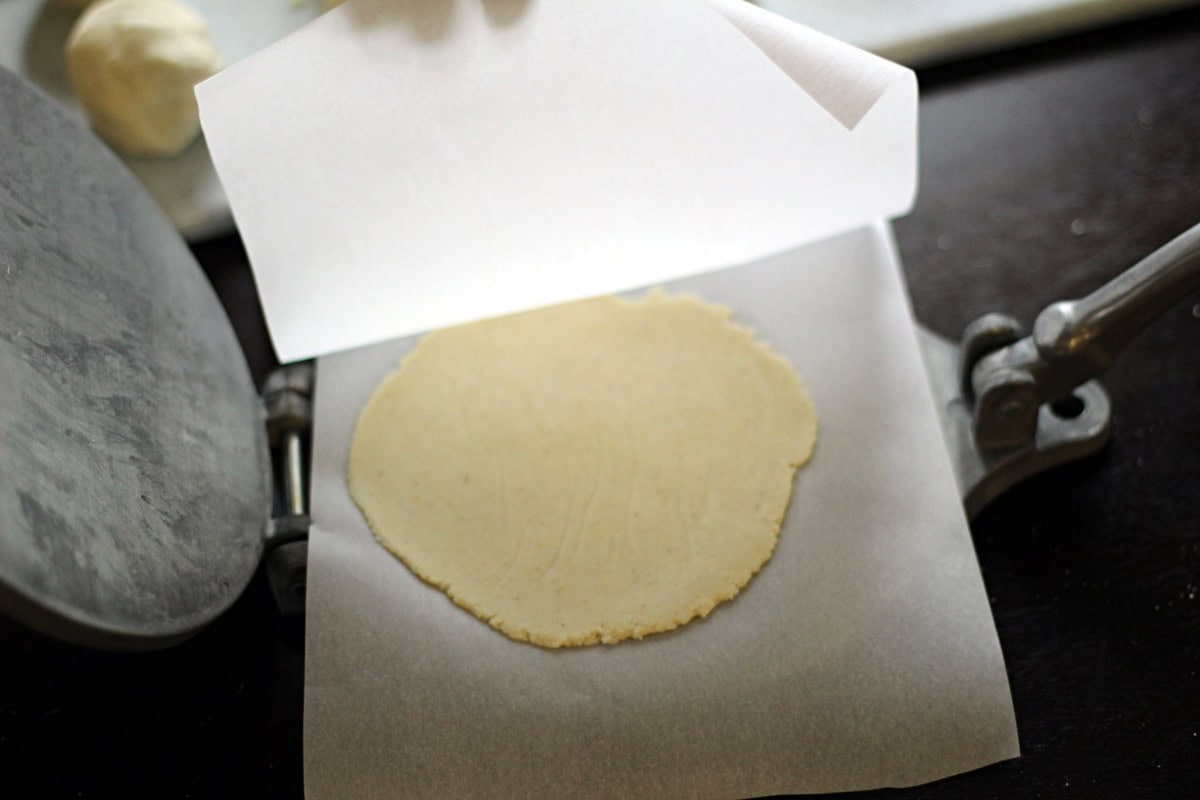Flattening the tortilla.