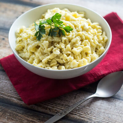 Homemade German Spaetzle in white bowl.