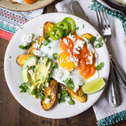 Huevos Motuleños served on a white plate.