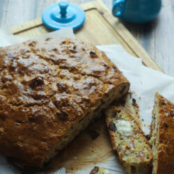 Slices of Irish raisin soda bread arranged on a parchment-lined board.
