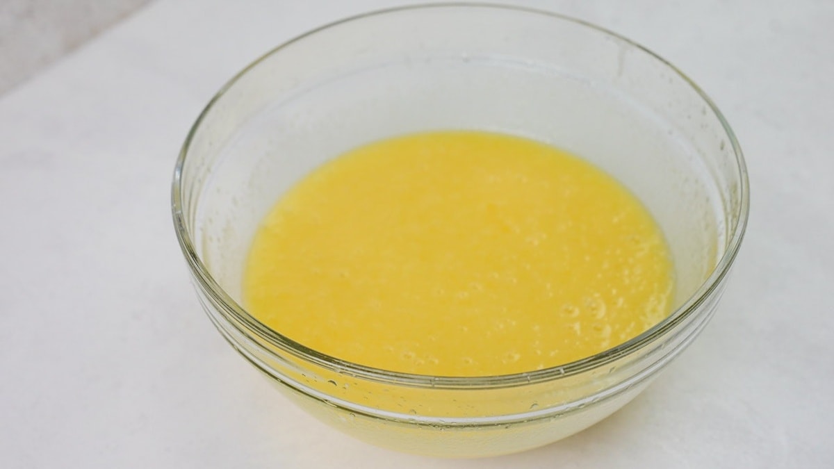 Eggs added into batter in a clear bowl.