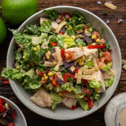 Enjoy a Latin twist on a classic dish with this Mexican Caesar Salad. Savory chicken and fresh vegetables on a bed of crisp lettuce and topped with a creamy Caesar-salsa dressing.