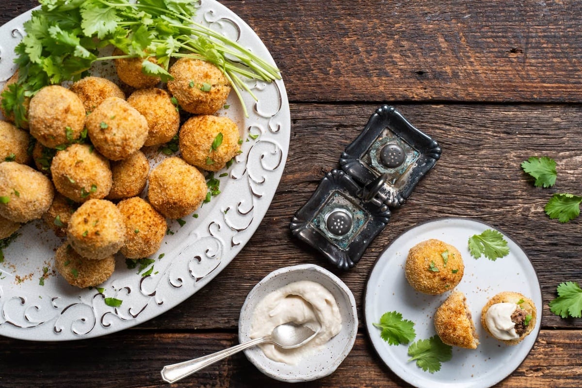 Papas rellenas served on a white plate.