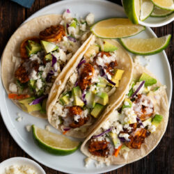 These Baja Shrimp Tacos combine spicy shrimp with a citrusy pineapple coleslaw topped with fresh avocado and creamy cheese to create a one of a kind taco!