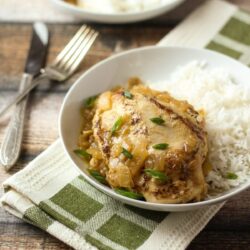 Chicken Yassa served on a white plate.