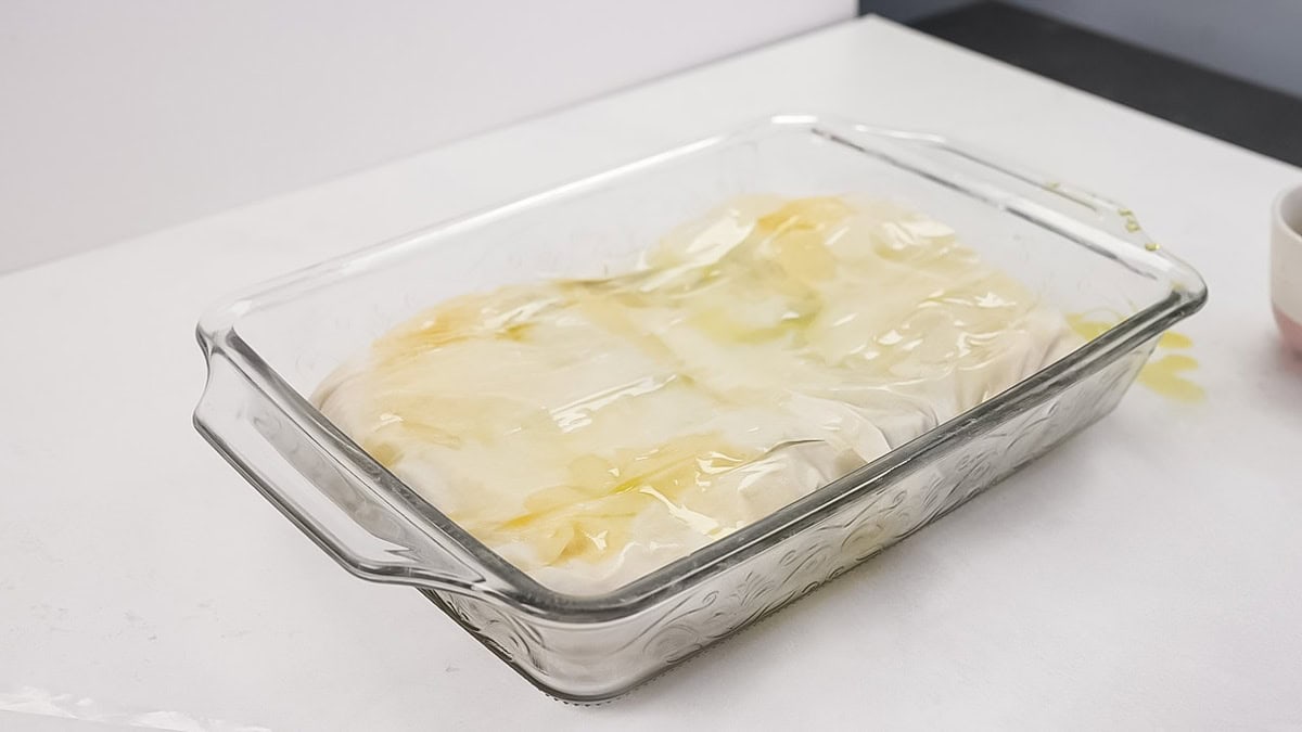 A baking dish layered with phyllo dough.