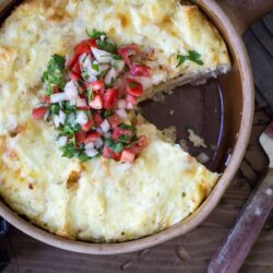 Sliced portion of vegetarian breakfast casserole in a round dish.