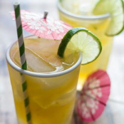 A highball glass filled with a Bourbon and Ginger cocktail.