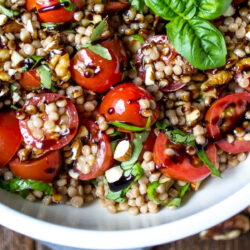 Tomato couscous salad in a white bowl.